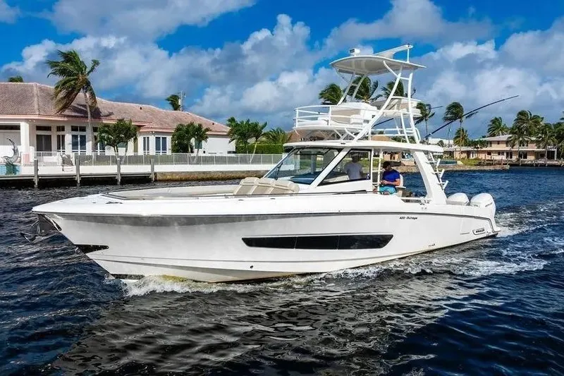 Slide: The Image of 2022 Boston Whaler 420 Outrage cruising on a sunny day near waterfront homes. - 5