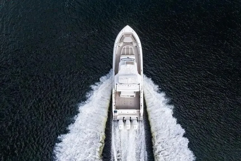 Slide: The Image of Aerial view of 2022 Boston Whaler 420 Outrage cruising on water. - 9