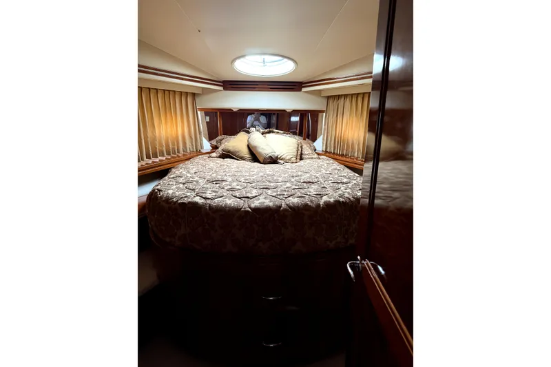 Slide: The Image of Luxurious bedroom interior of 2005 Carver 570 Voyager Pilothouse yacht with plush bedding. - 10