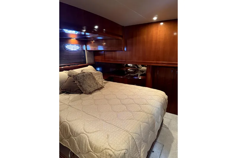 Slide: The Image of Luxurious bedroom interior of 2005 Carver 570 Voyager Pilothouse yacht with elegant wood finish. - 11
