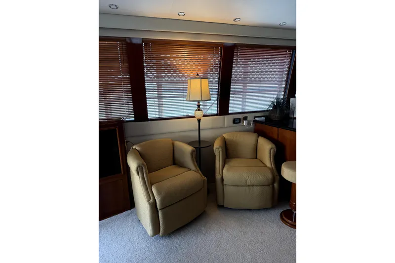 Slide: The Image of Luxurious interior of 2005 Carver 570 Voyager Pilothouse with elegant seating and wooden finishes. - 3