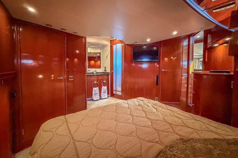 Slide: The Image of Luxurious interior of 2005 Carver 570 Voyager Pilothouse yacht bedroom with wood finish. - 33