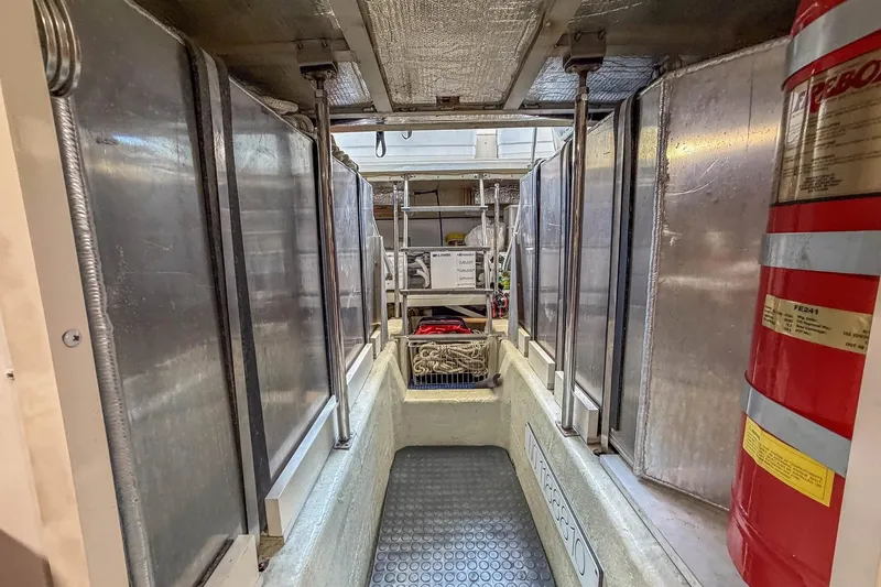 Slide: The Image of Engine room of 2005 Carver 570 Voyager Pilothouse with fire extinguisher and equipment. - 43