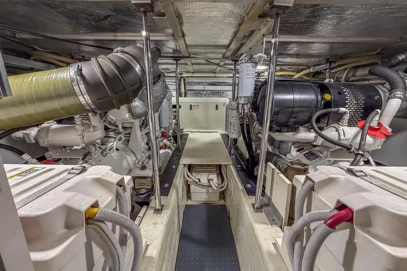 Slide: The Image of Engine room of 2005 Carver 570 Voyager Pilothouse yacht, showcasing mechanical components. - 44