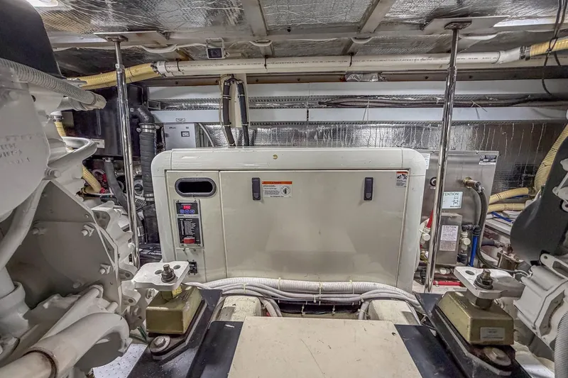 Slide: The Image of Engine room of 2005 Carver 570 Voyager Pilothouse with machinery and equipment. - 45