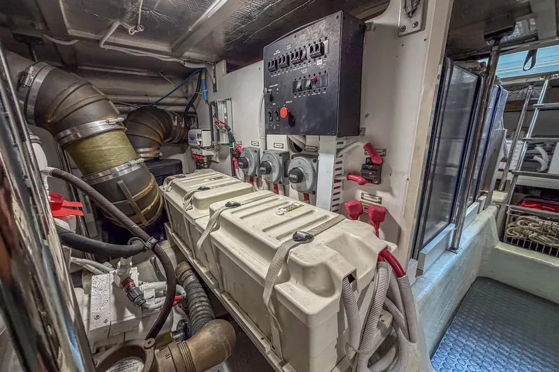 Slide: The Image of Engine room of 2005 Carver 570 Voyager Pilothouse with control panel and machinery. - 48