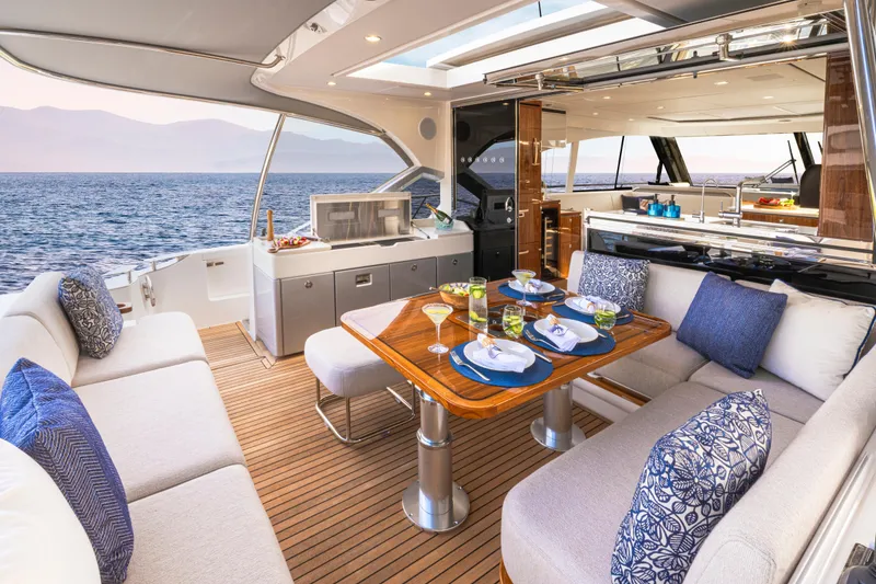Slide: The Image of Luxurious 2026 Riviera 5600 Sport Yacht Platinum Edition with elegant outdoor dining area. - 3