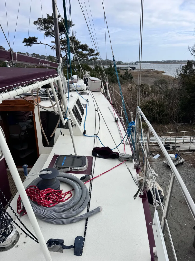 Slide: The Image of Bruce Roberts 64 Custom Steel Cruiser, deck view, 1999, parked by the shore. - 8