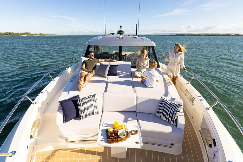 Slide: The Image of Manufacturer Provided Image: People relaxing on a 2026 Riviera 4300 Sport Express yacht, enjoying a sunny day at sea. - 2