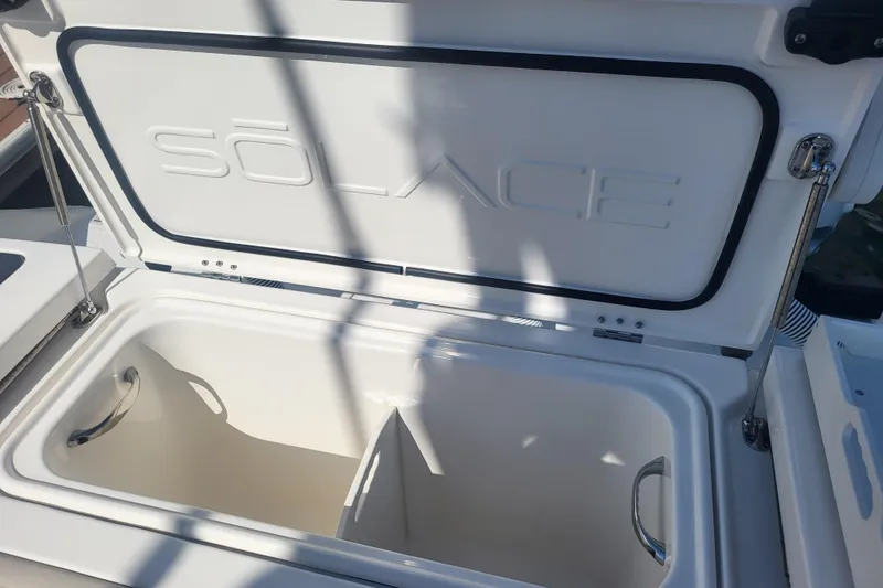 Slide: The Image of Open storage compartment on 2026 Solace 37 Pilot boat, featuring sleek design and sturdy handles. - 12