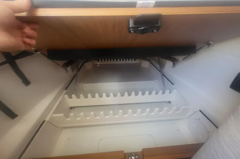 Slide: The Image of Storage compartment in 2026 Solace 37 Pilot boat, featuring organized shelving. - 17