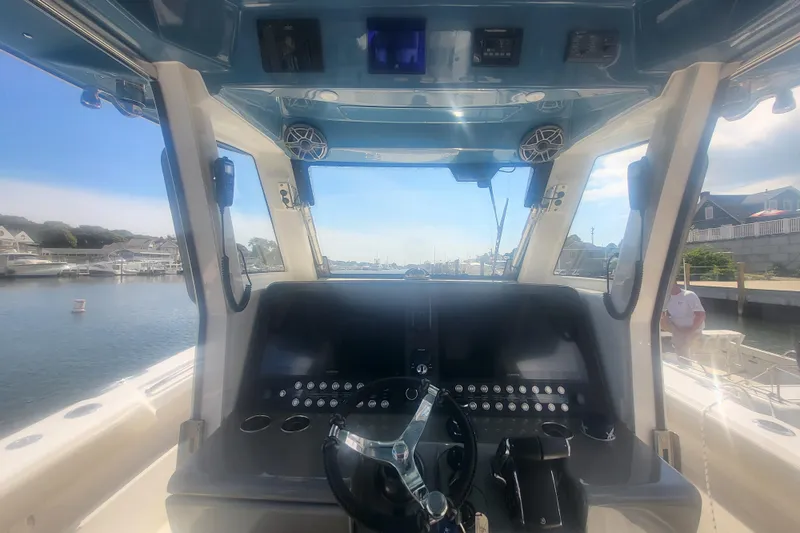 Slide: The Image of Interior view of 2026 Solace 37 Pilot boat cockpit with steering wheel and controls. - 21