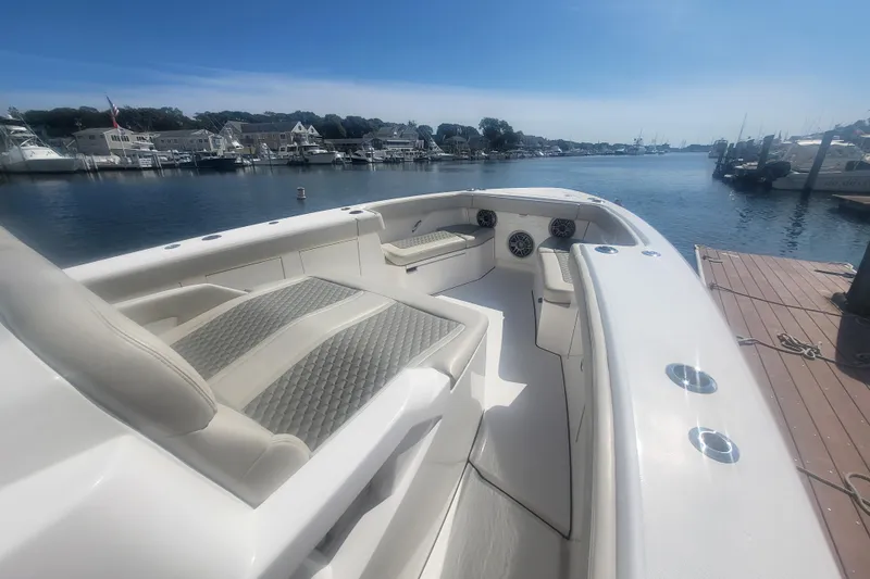 Slide: The Image of 2026 Solace 37 Pilot boat docked, featuring spacious seating and waterfront view. - 26