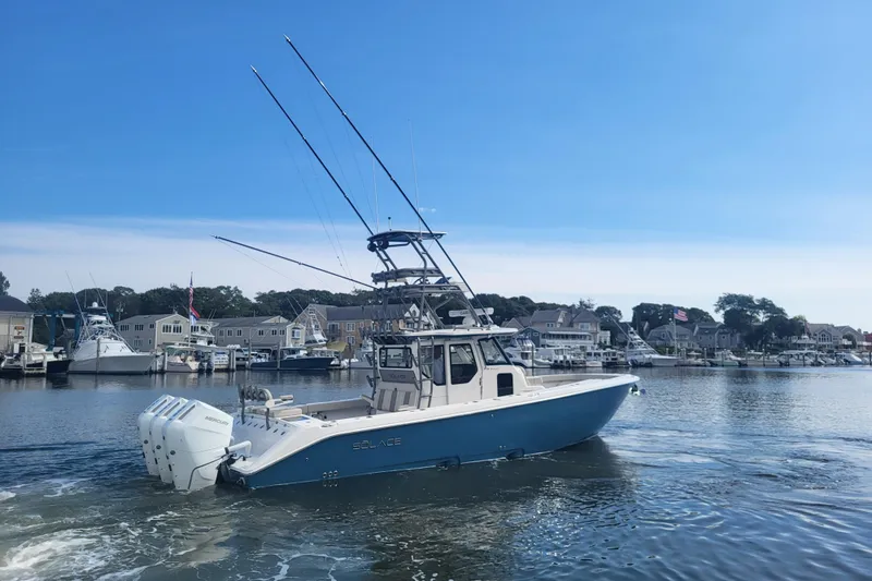 Slide: The Image of 2026 Solace 37 Pilot boat cruising in a marina with clear blue skies. - 3