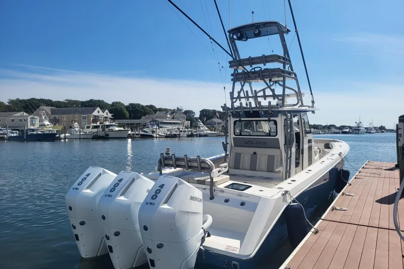 Slide: The Image of 2026 Solace 37 Pilot boat docked with triple Mercury 400 engines. - 4