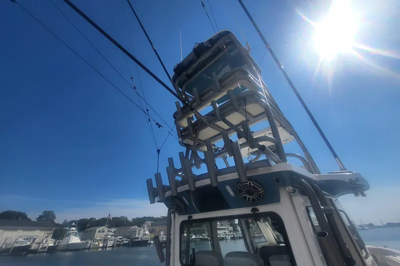 Slide: The Image of 2026 Solace 37 Pilot boat under bright sun, docked at marina. - 5