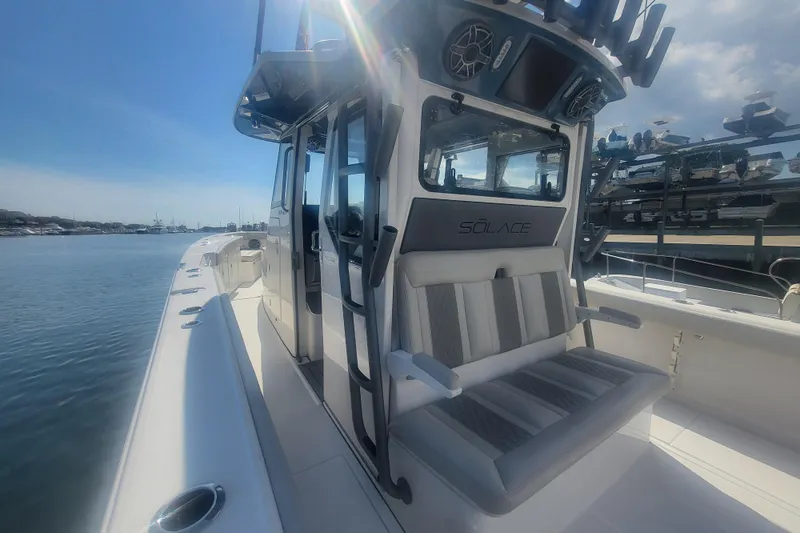 Slide: The Image of 2026 Solace 37 Pilot boat with sleek design, docked under clear blue sky. - 7