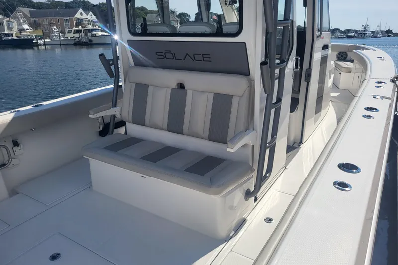 Slide: The Image of 2026 Solace 37 Pilot boat interior with seating, docked at a marina. - 8