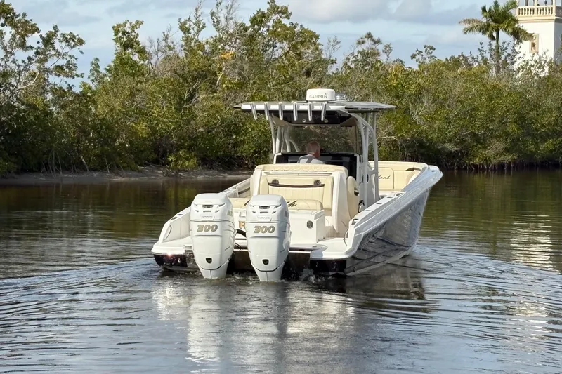 Slide: The Image of 2012 Nor-Tech 340 Sport Center Console boat cruising on calm water. - 10