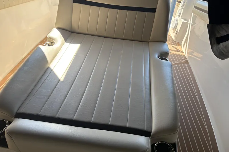 Slide: The Image of Interior seating of 2012 Nor-Tech 340 Sport Center Console boat with cup holders. - 13