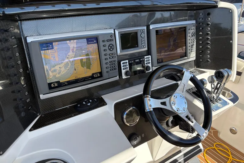 Slide: The Image of 2012 Nor-Tech 340 Sport Center Console dashboard with GPS navigation and steering wheel. - 14