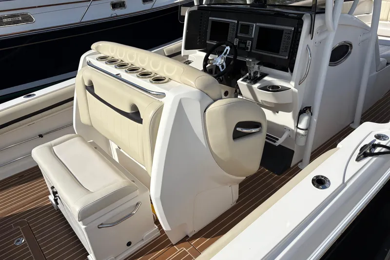 Slide: The Image of 2012 Nor-Tech 340 Sport Center Console with beige seating and advanced navigation controls. - 17