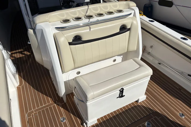 Slide: The Image of 2012 Nor-Tech 340 Sport Center Console interior with beige seating and wood-patterned flooring. - 18