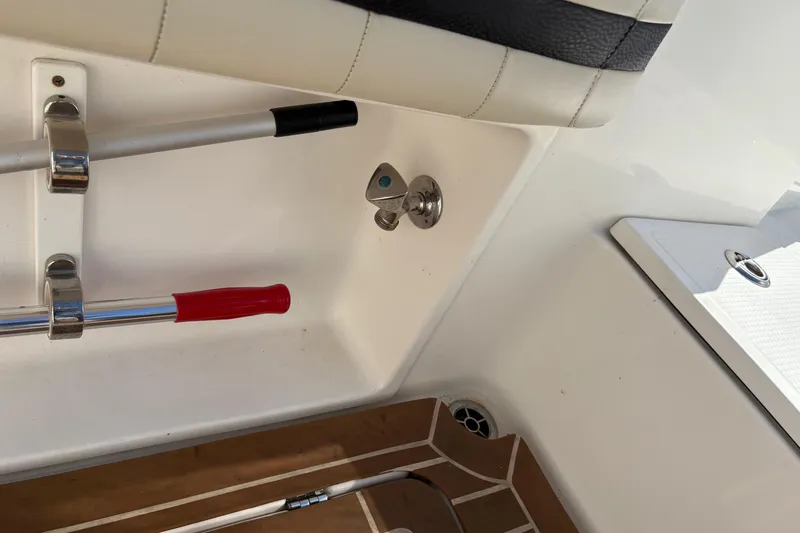 Slide: The Image of 2012 Nor-Tech 340 Sport Center Console interior with rod holder and deck details. - 24