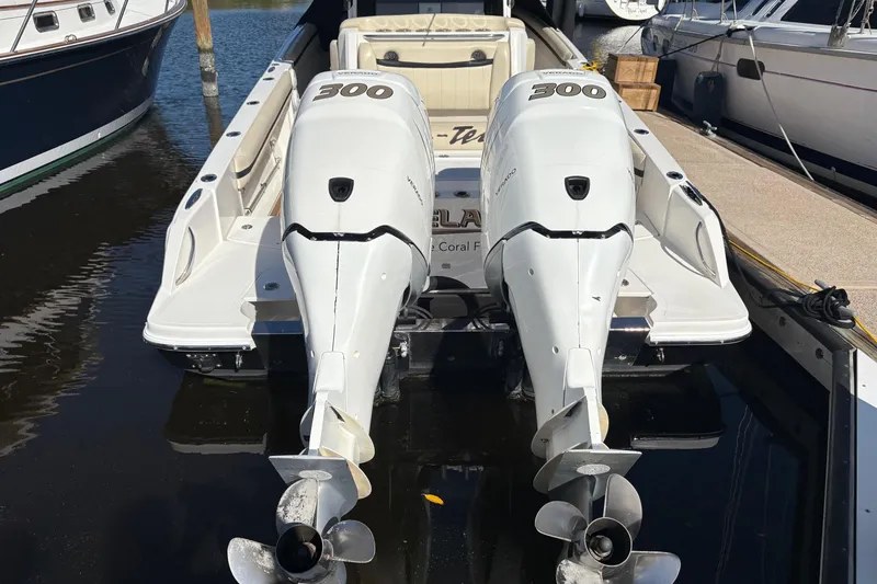 Slide: The Image of 2012 Nor-Tech 340 Sport Center Console with twin 300 horsepower engines docked at marina. - 25