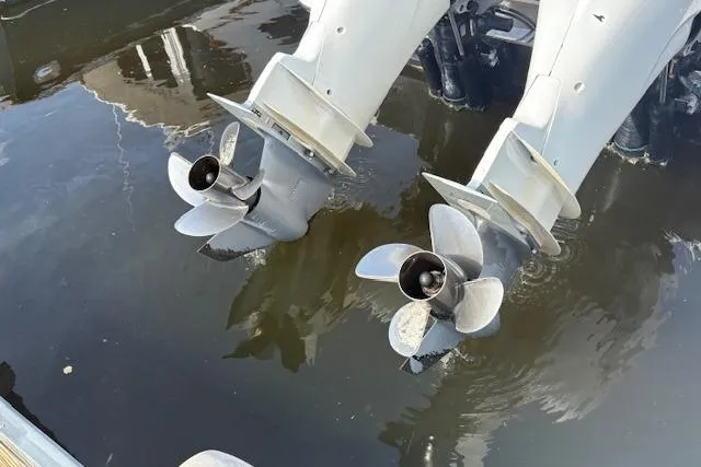 Slide: The Image of Twin outboard motors of a 2012 Nor-Tech 340 Sport Center Console in water. - 26