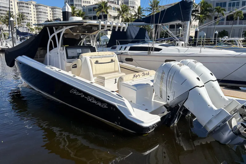 Slide: The Image of 2012 Nor-Tech 340 Sport Center Console boat docked with twin Mercury engines. - 27