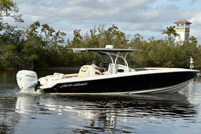 Slide: The Image of 2012 Nor-Tech 340 Sport Center Console boat cruising on calm water. - 3