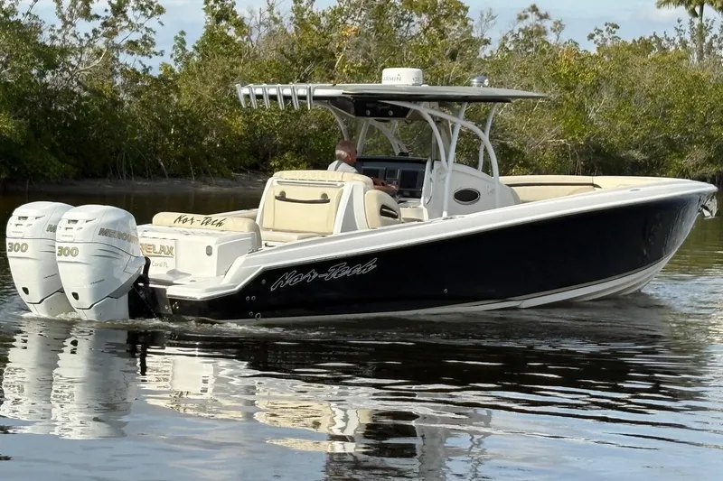 Slide: The Image of 2012 Nor-Tech 340 Sport Center Console boat cruising on calm water. - 5