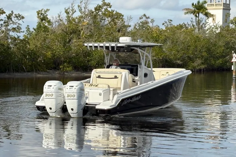 Slide: The Image of 2012 Nor-Tech 340 Sport Center Console boat with twin 300 engines on calm water. - 6