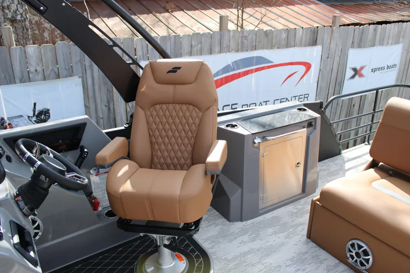 Slide: The Image of Captain's chair on 2026 Starcraft RX 23 Q DH boat, featuring luxury seating and control panel. - 10