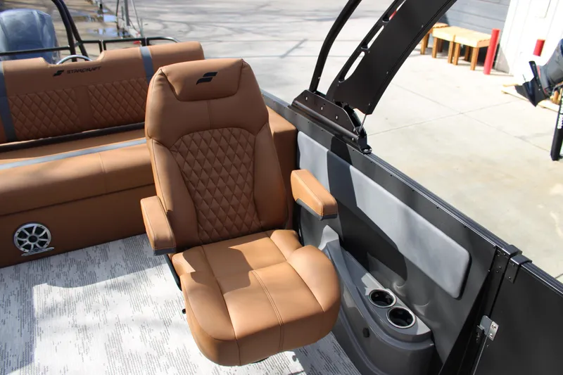 Slide: The Image of Luxurious seating on 2026 Starcraft RX 23 Q DH boat, featuring tan leather and modern design. - 12