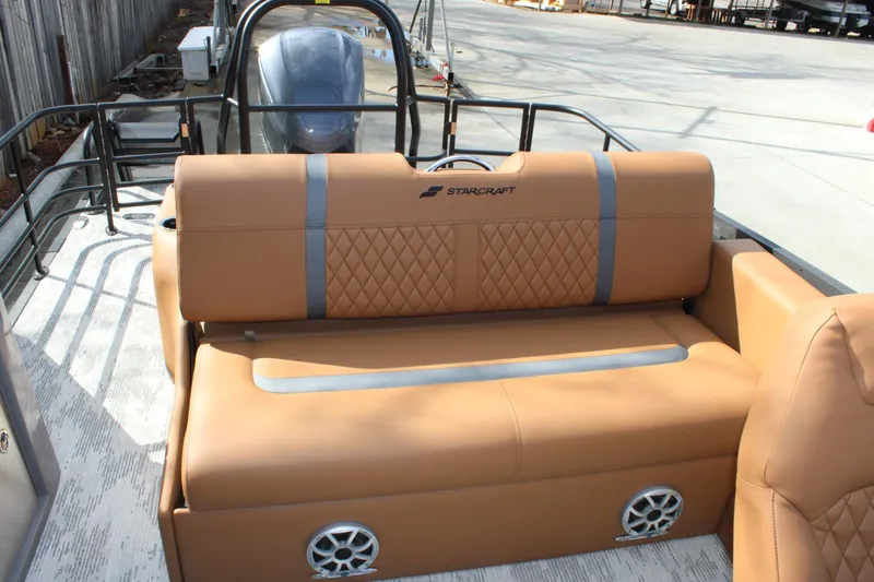 Slide: The Image of 2026 Starcraft RX 23 Q DH boat interior with tan seating and modern design. - 13