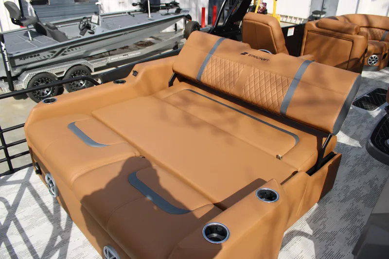 Slide: The Image of 2026 Starcraft RX 23 Q DH boat with luxurious tan seating and cup holders. - 14