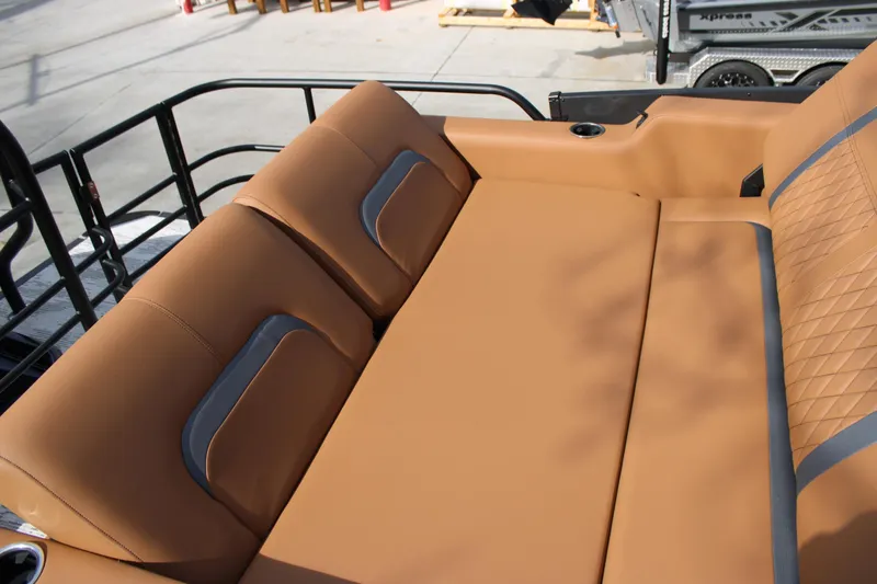 Slide: The Image of Luxurious tan seating on 2026 Starcraft RX 23 Q DH boat, featuring quilted design and cup holder. - 15