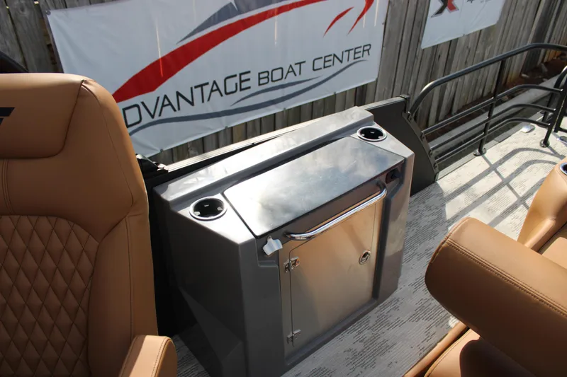 Slide: The Image of 2026 Starcraft RX 23 Q DH boat interior with tan seating and stainless steel storage. - 20