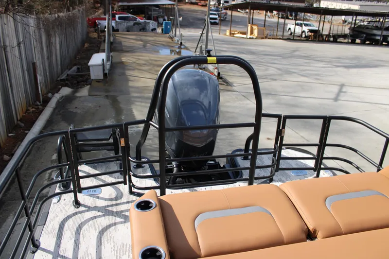 Slide: The Image of 2026 Starcraft RX 23 Q DH boat with tan seating and outboard motor in a marina. - 21