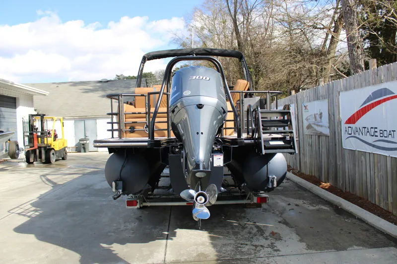 Slide: The Image of 2026 Starcraft RX 23 Q DH boat with powerful outboard motor, parked outdoors. - 3