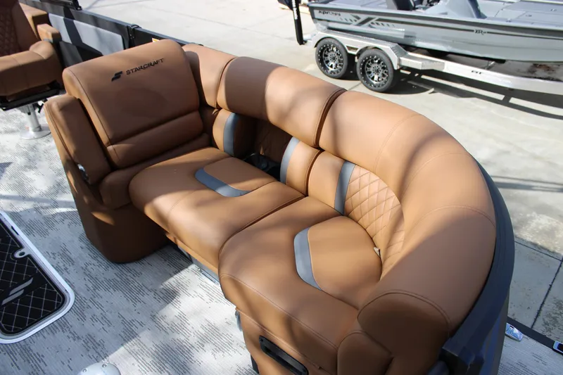 Slide: The Image of Luxurious brown seating on 2026 Starcraft RX 23 Q DH boat, showcasing comfort and style. - 4