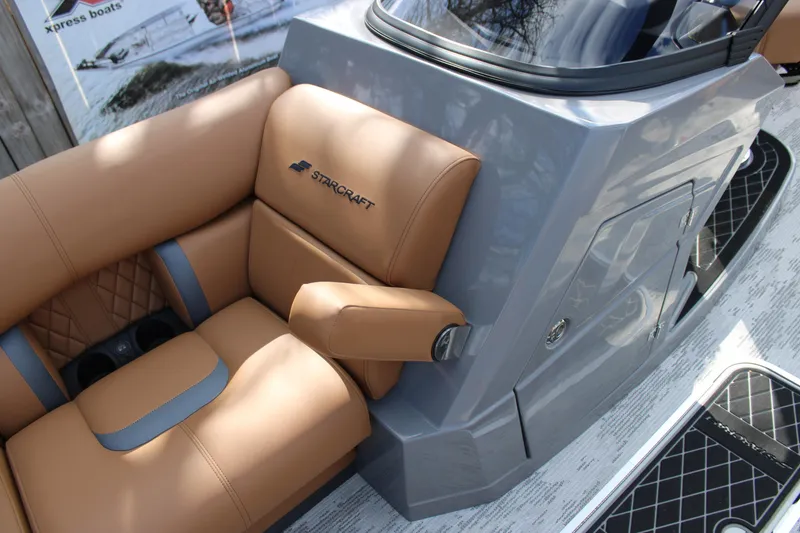 Slide: The Image of Luxurious seating on 2026 Starcraft RX 23 Q DH boat, featuring tan upholstery and sleek design. - 7