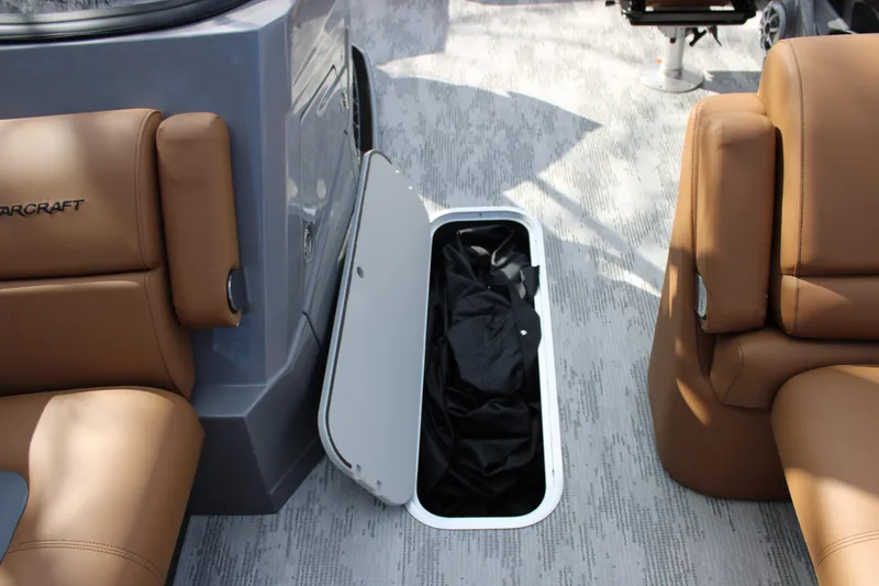 Slide: The Image of Starcraft RX 23 Q DH 2026 boat interior with open storage compartment. - 9
