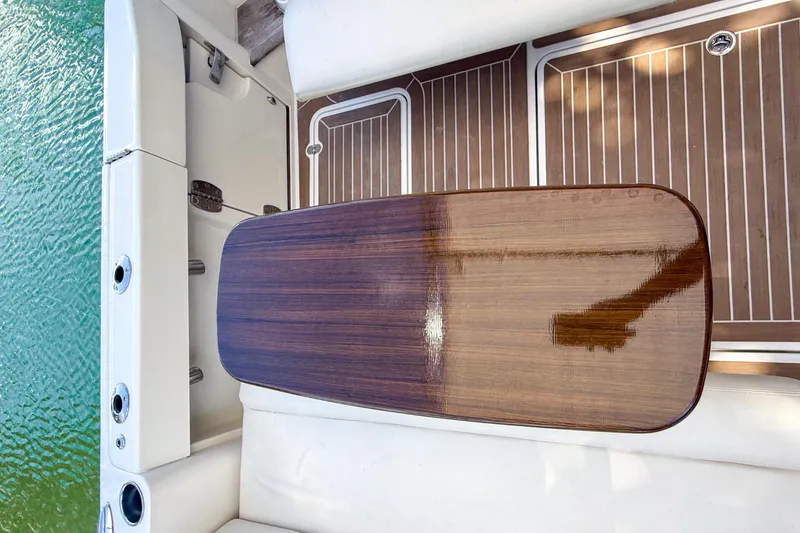 Slide: The Image of Luxurious seating on 2021 Hinckley Sport Boats 40x, featuring white leather and wooden flooring. - 12