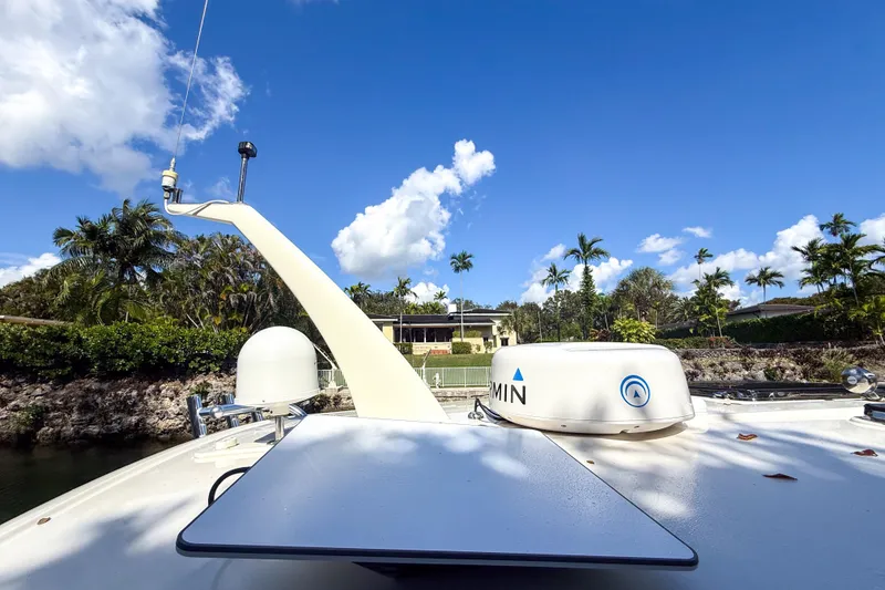 Slide: The Image of 2021 Hinckley Sport Boats 40x cruising through a scenic, tree-lined canal. - 28