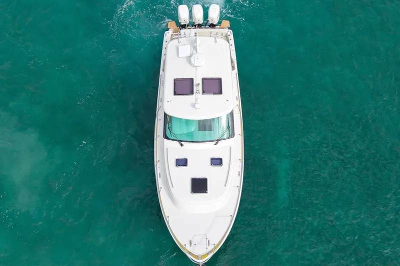 Slide: The Image of 2021 Hinckley Sport Boats 40x cruising on clear blue water under a sunny sky. - 3