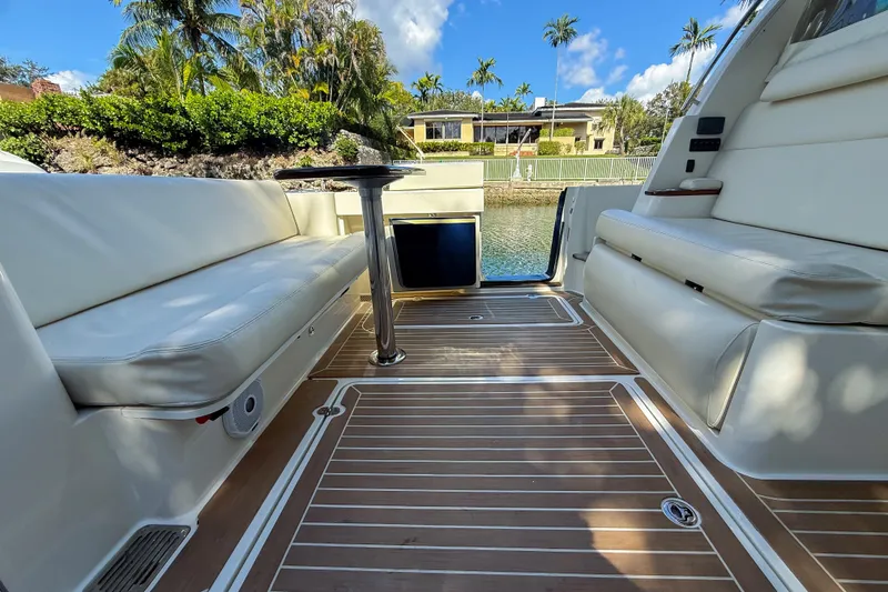 Slide: The Image of 2021 Hinckley Sport Boats 40x interior with seating, table, and outdoor kitchen. - 9