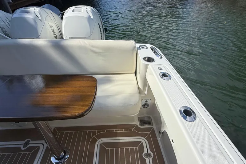 Slide: The Image of Hinckley Sport Boats 40x 2021 interior with polished wood table and cushioned seating. - 13